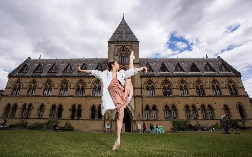Merritt doing standing splits in front of an iconic Oxford building